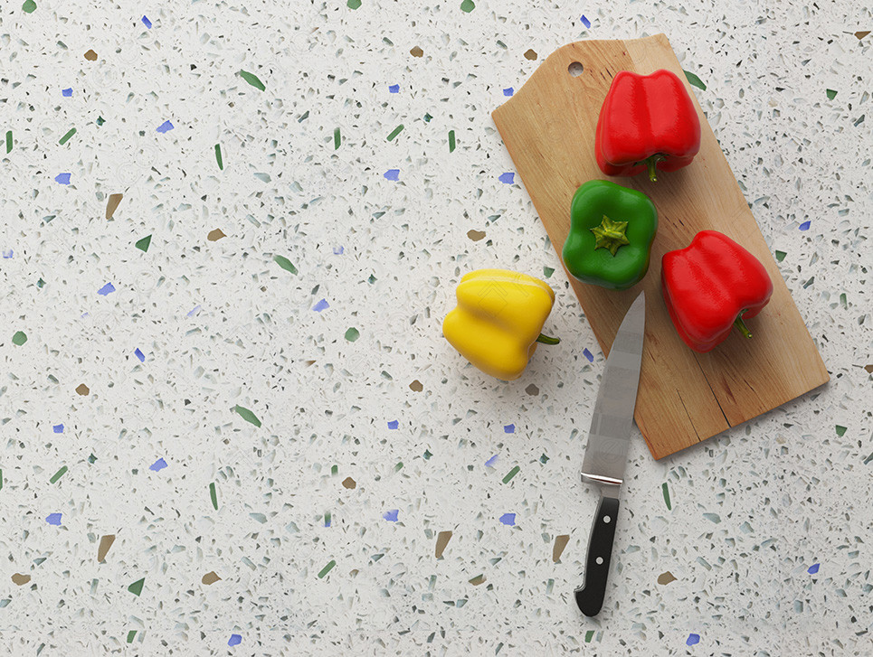 Glass countertop with a cutting board, knife, and different color peppers
